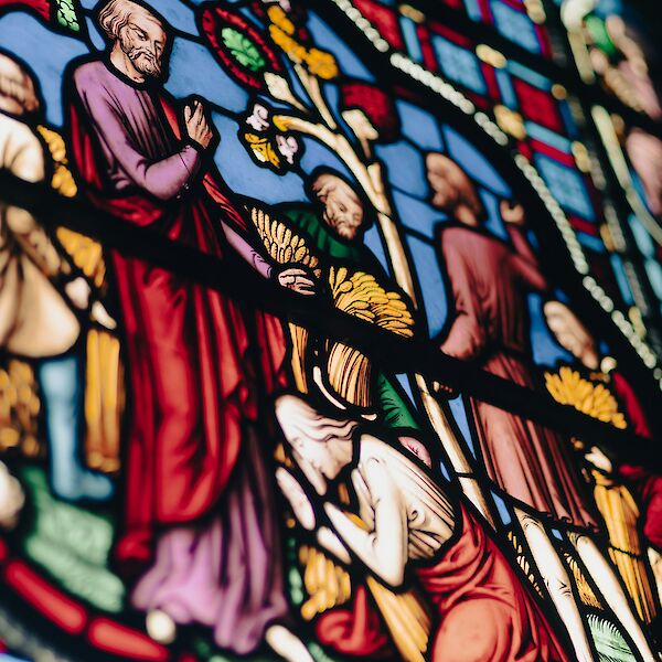 Stained glass depiction of Joseph forgiving his brothers, depicted in Ely Cathedral. Photo by Ben Wicks, Unsplash.