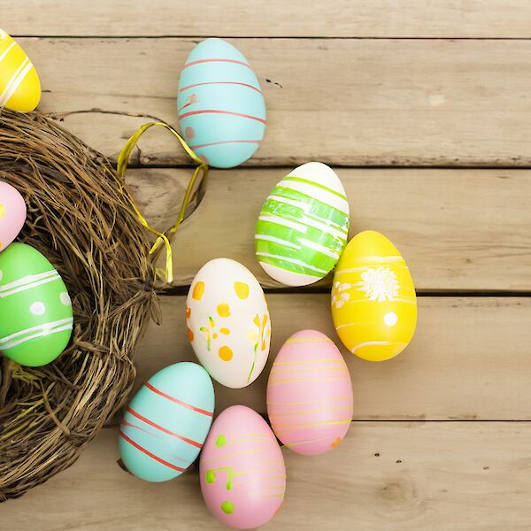 colorful easter eggs on wooden surface. Photo by Aleyna Çatak, Unsplash.